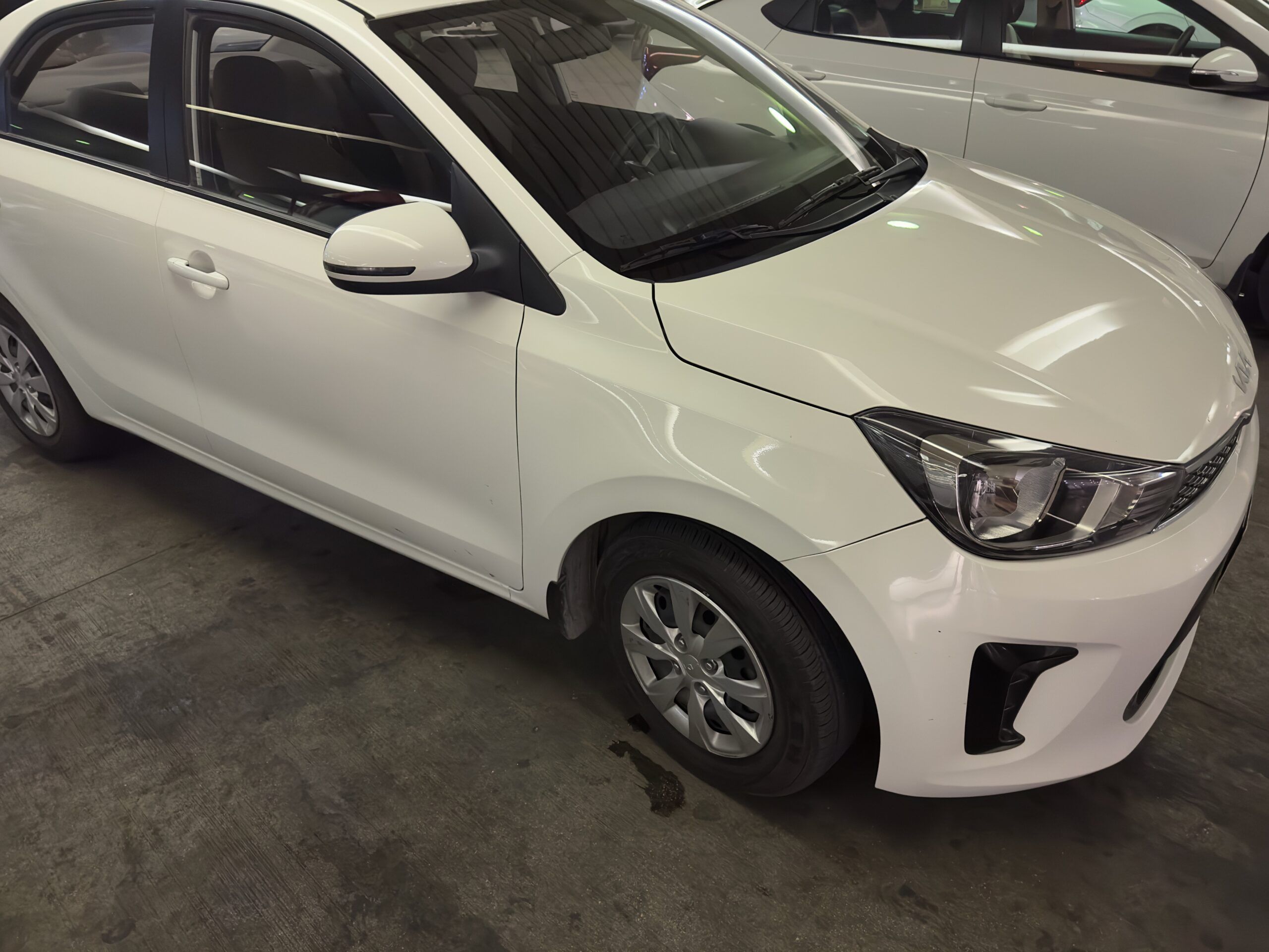 White rental car in saudi arabia, shown in a parking garage.