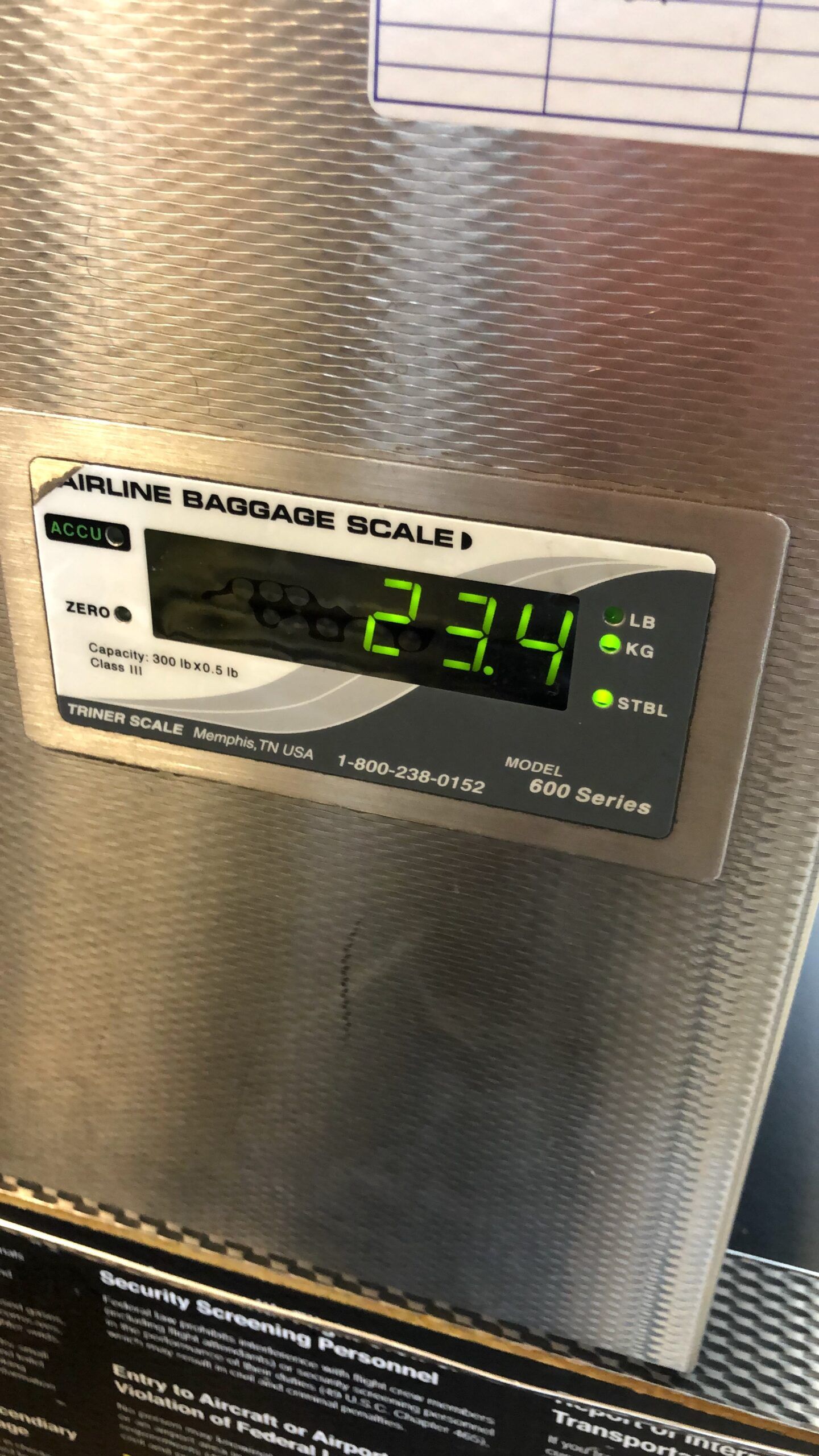 Airline baggage scale showing 23. 4 lb and 23. 4 kg on the lost luggage article photo