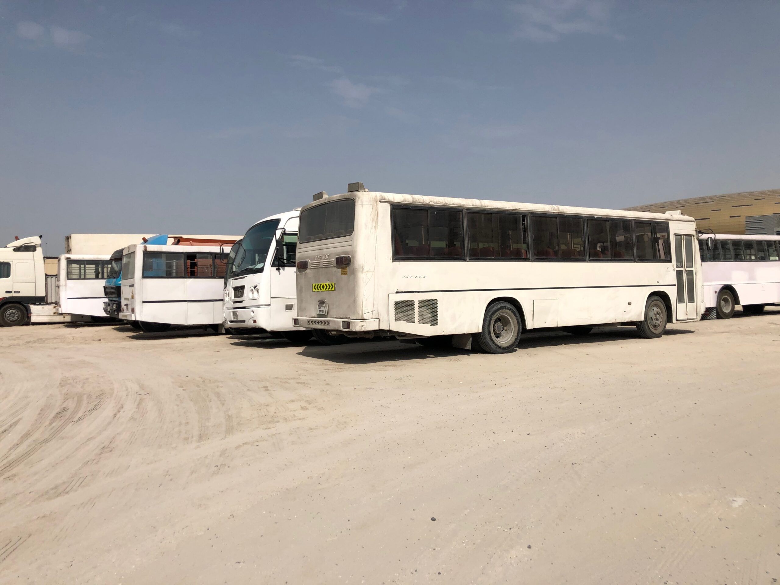 Autobusy i ciężarówki na piaszczystym placu w dubaju, zea