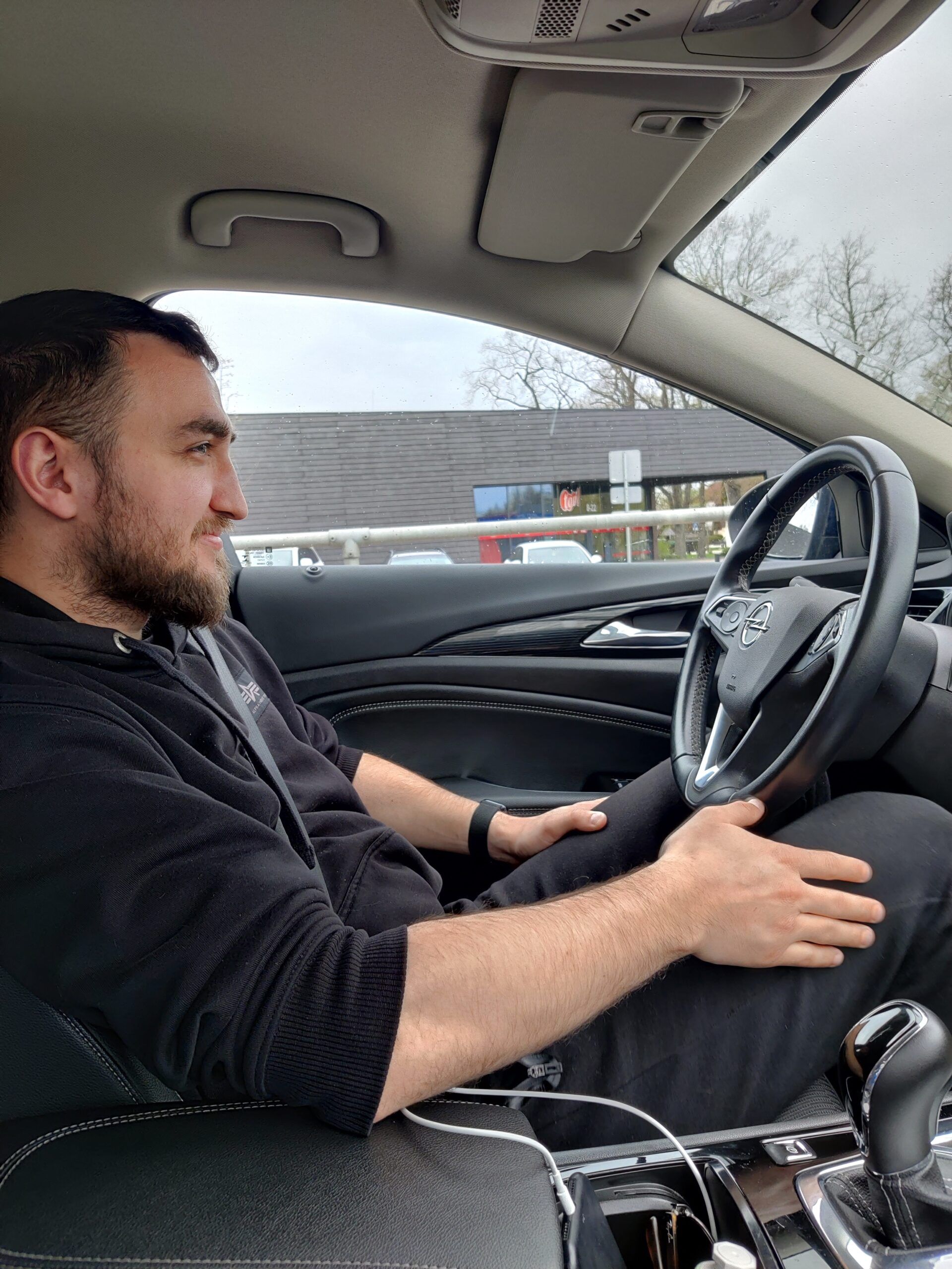 Man driving in tallinn, estonia, seen from the front passenger seat inside a car