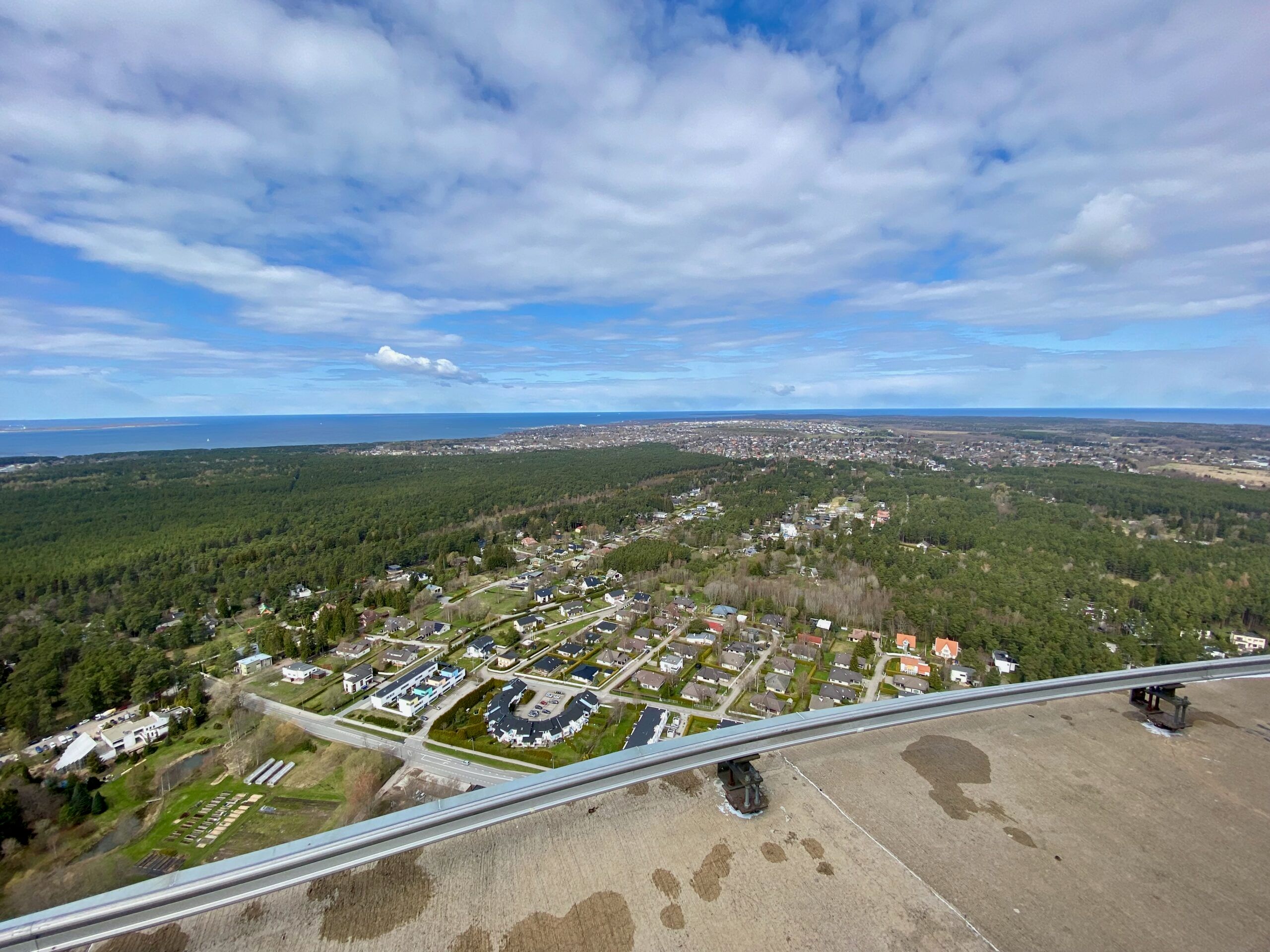 Estonia, tallinn article photo view over suburban rooftops and green forests toward the distant coastline