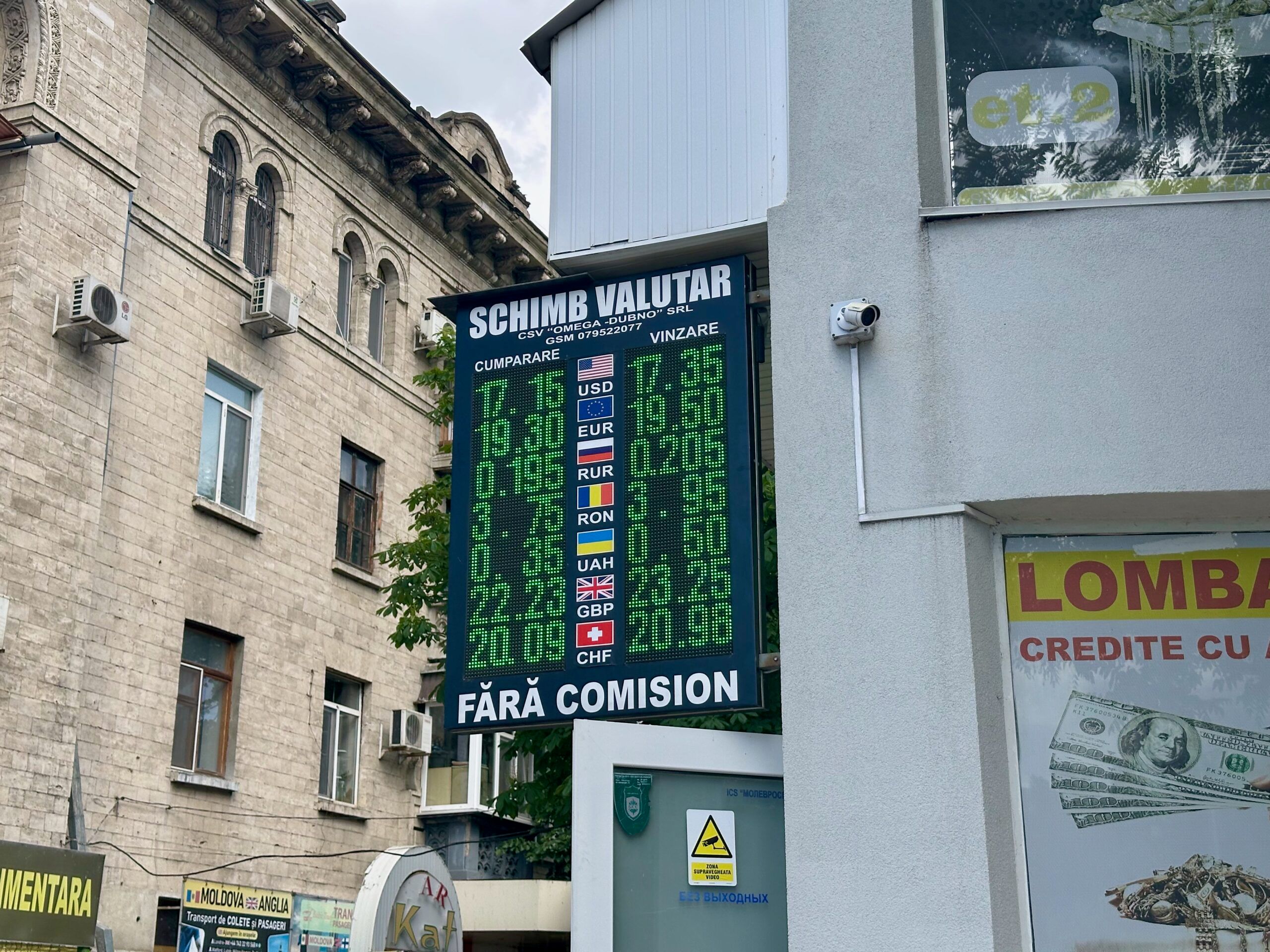 Chisinau exchange office in moldova with a green led currency rate board and sign showing “schimb valutar”