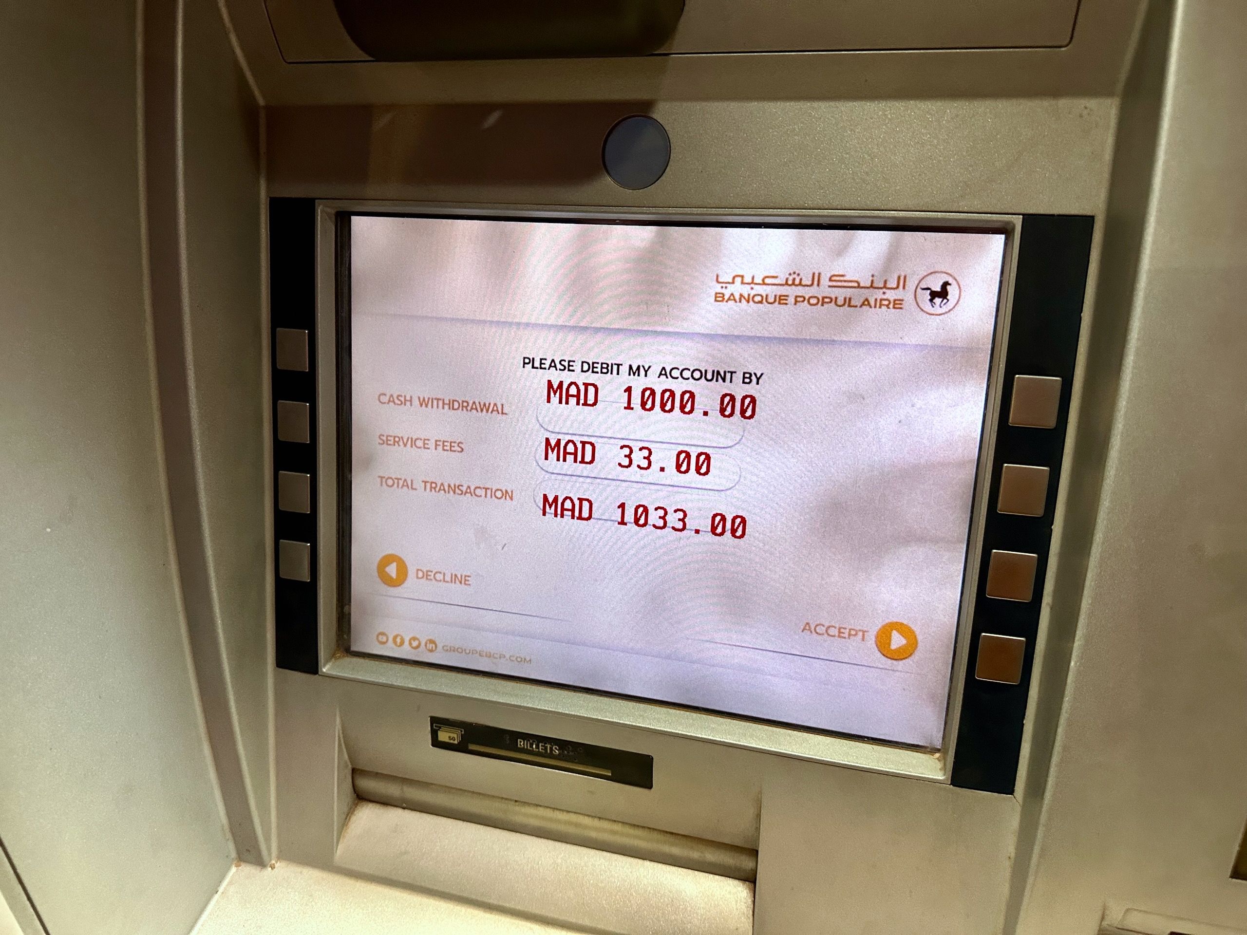 Morocco, marrakech atm screen showing a cash withdrawal transaction total of mad 1033. 00