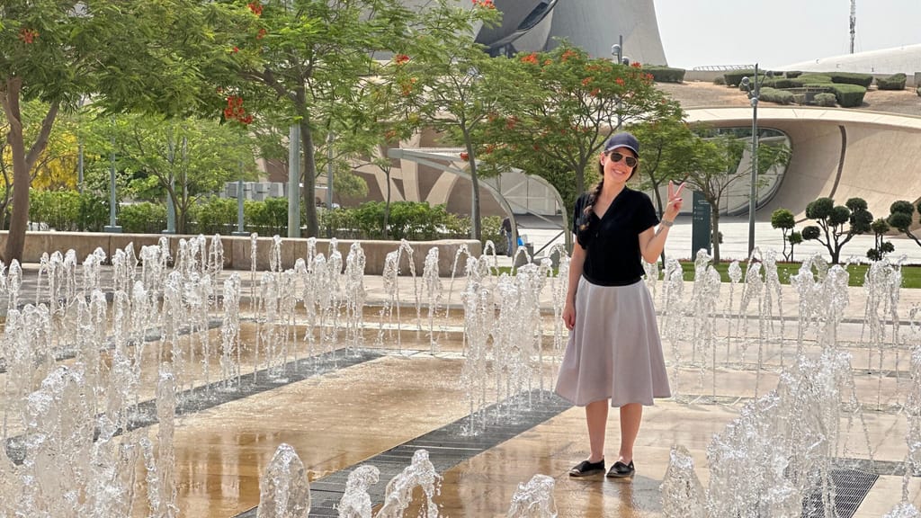 Woman posing by fountain jets at ithra, dammam, saudi arabia