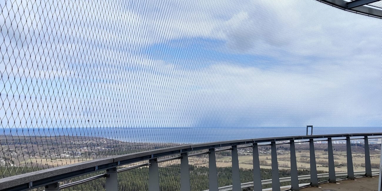 Tallinn, estonia, seaside walkway with metal railings and a cloudy horizon.