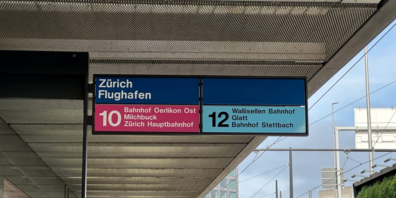 Przystanek przy zürich flughafen z tablicami linii tramwajowych 10 i 12.