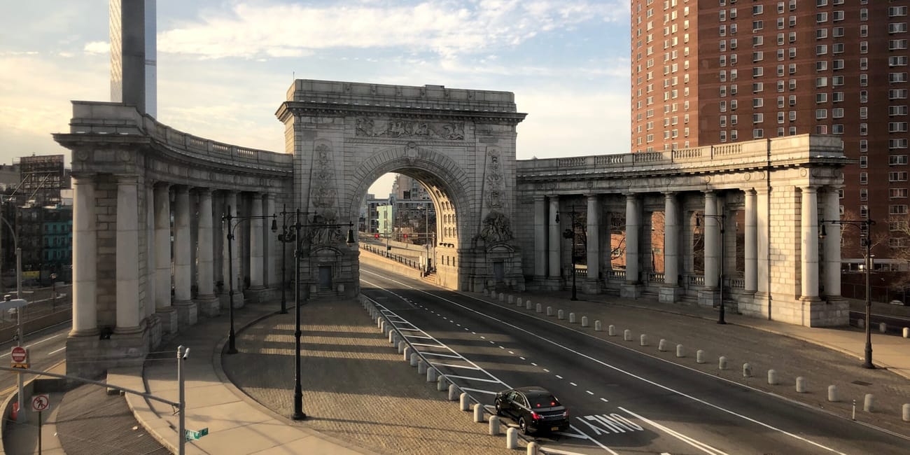 Łuk triumfalny przy washington square w nowym jorku z pustą ulicą o zachodzie słońca
