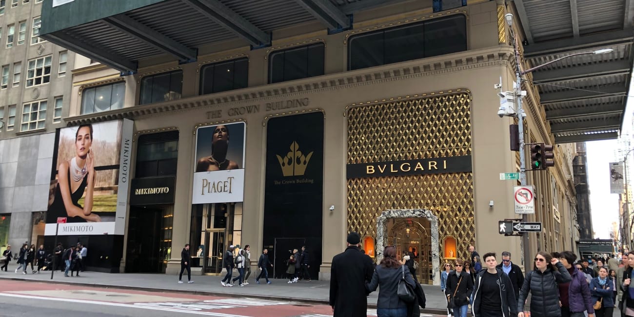 Fasada crown building przy 5th avenue w nowym jorku z butikami bulgari, mikimoto i piaget.