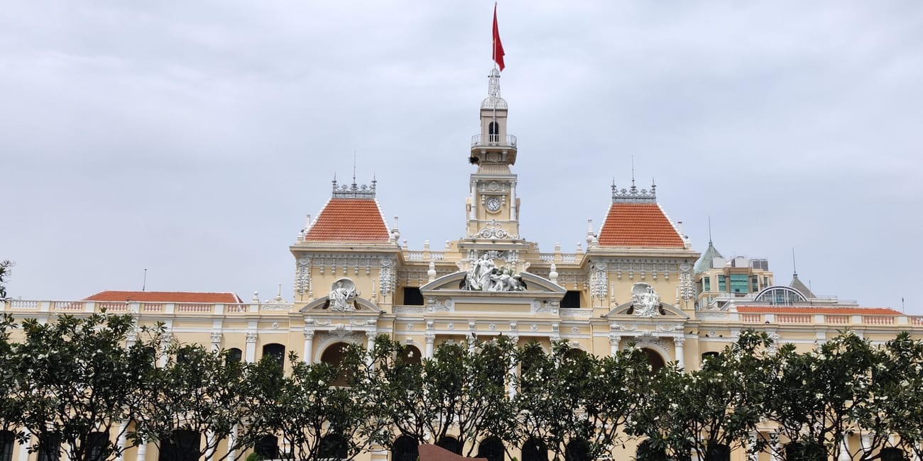 Ratusz w ho chi minh, z wieżą zegarową i czerwoną flagą na szczycie