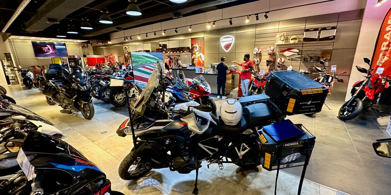 Desert horizons motorcycle expedition in kuwait: showroom full of touring motorcycles and staff.
