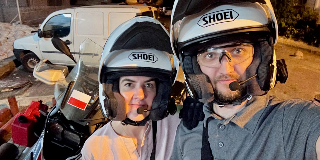 Motorcyclists in helmets posing at night with a motorcycle in istanbul, turkey
