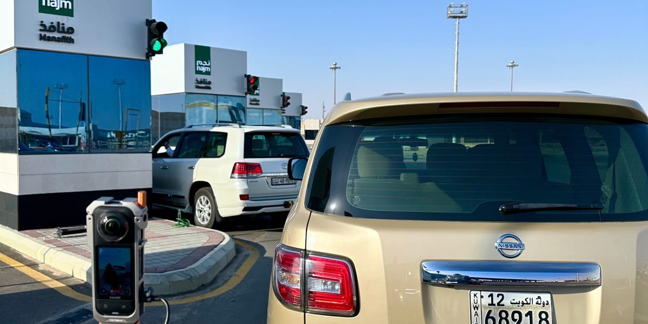 Desert horizons motorcycle expedition in saudi arabia, beige nissan patrol parked at a checkpoint beside “najm” buildings