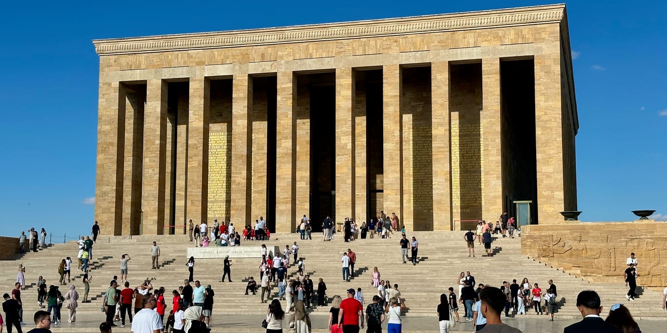 Visitors walking in front of the anıtkabir mausoleum in ankara, turkey under a blue sky
