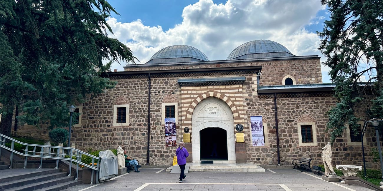 Ankara civilization museum entrance with stone arches and two domes under a blue sky