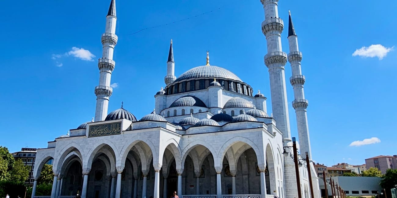 Turkey, ankara melike hatun mosque with minarets and domed roof under a clear blue sky
