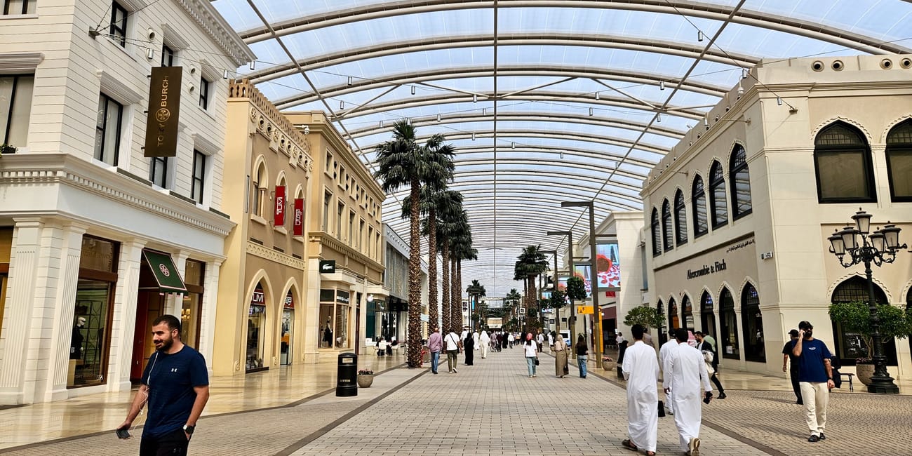 Kuwait city, the avenues indoor shopping arcade with arched glass roof and shoppers walking.