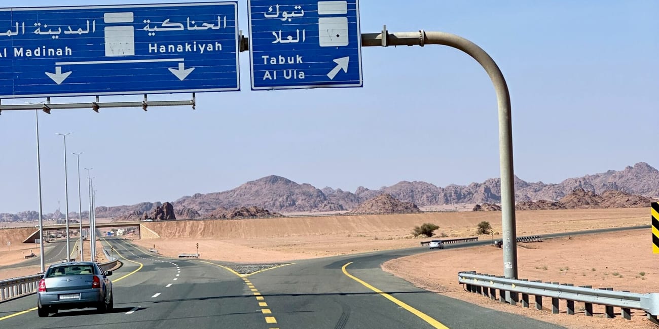 Saudi arabia al ula road exit sign with arabic and english directions to tabuk and al ula