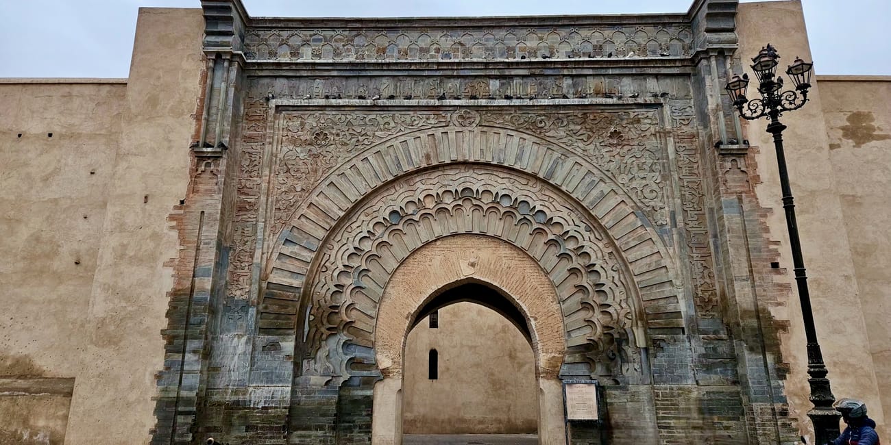 Bab agnaou in marrakesh, morocco, with a large arched entrance and ornate carved facade