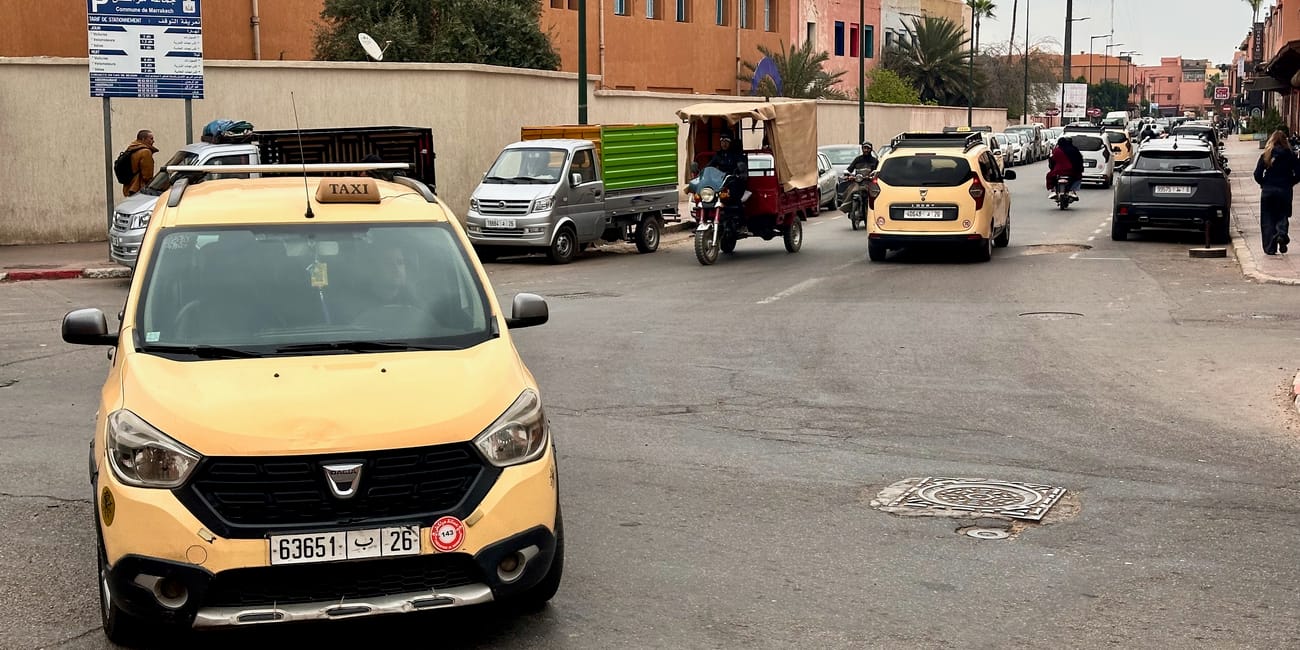Yellow taxi car at a busy street in marrakech taxis, morocco, with vehicles waiting in traffic