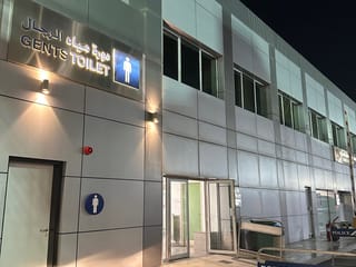 Bahrain police facility with a gents toilet entrance at night