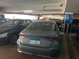 Car rental parking garage in egypt with a gray toyota corolla