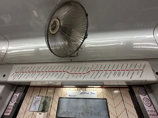 Nasser metro station in egypt, with a route map and a large ceiling fan.