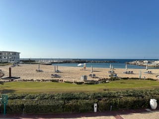 Sunrise alex avenue hotel beach in alexandria, egypt, with loungers and calm sea