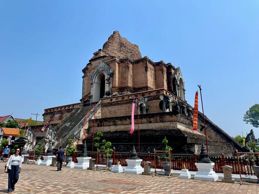 Świątynia w chiang mai z ceglanym chedi i schodami pod błękitnym niebem