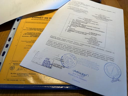 Dokumenty legalizacyjne pojazdu w turcji z pieczęciami i podpisami na biurku