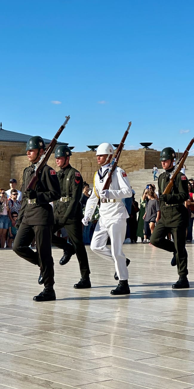 Turkish soldiers marching at ankara antikabir in turkey, with rifles and green and white uniforms.