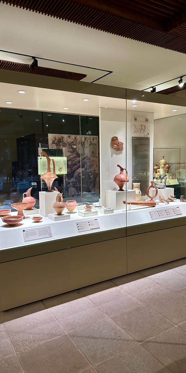 Turkey, ankara civilization museum: glass-walled gallery display with pottery and museum exhibits