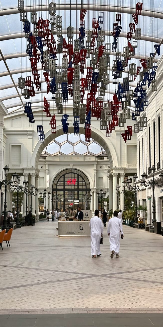 Kuwait city, the avenues: indoor shopping mall atrium with hanging metal sculptures and skylight ceiling