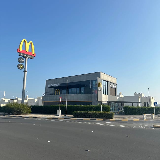 Mcdonald’s w bahrajnie przy szerokiej ulicy pod bezchmurnym niebem