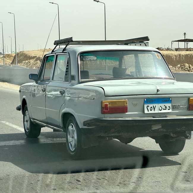 Vintage fiat 125 special driving on a road in egypt