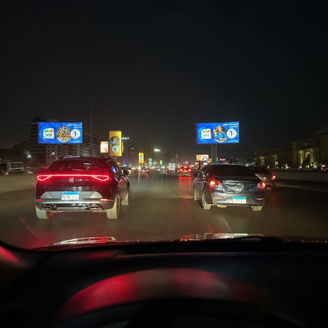 Night traffic on a lit highway in safety, egypt, seen from inside a car.