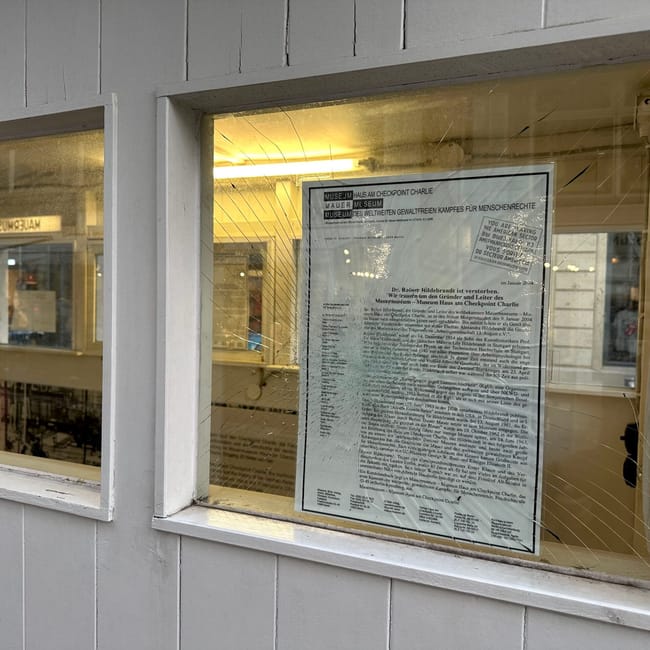 Przebita szyba z plakatem w muzeum haus am checkpoint charlie w berlinie.