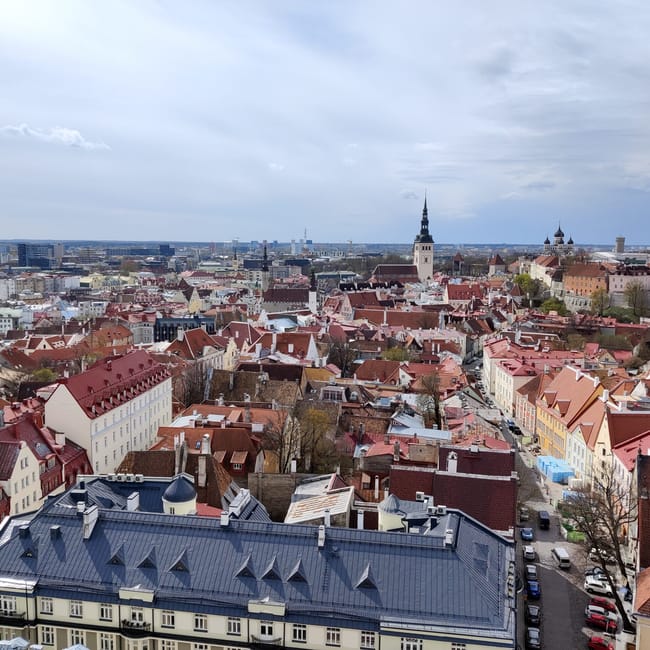 Tallinn, estonia skyline with red-roofed old town buildings and church spire under an overcast sky