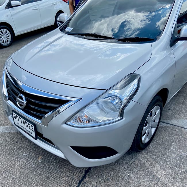 Silver nissan car parked on the street in chiang mai, thailand, with a clear front headlight view