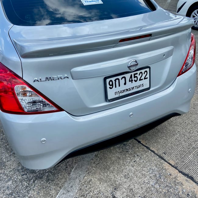 Rear view of a nissan almera car with a thailand license plate in chiang mai parking area