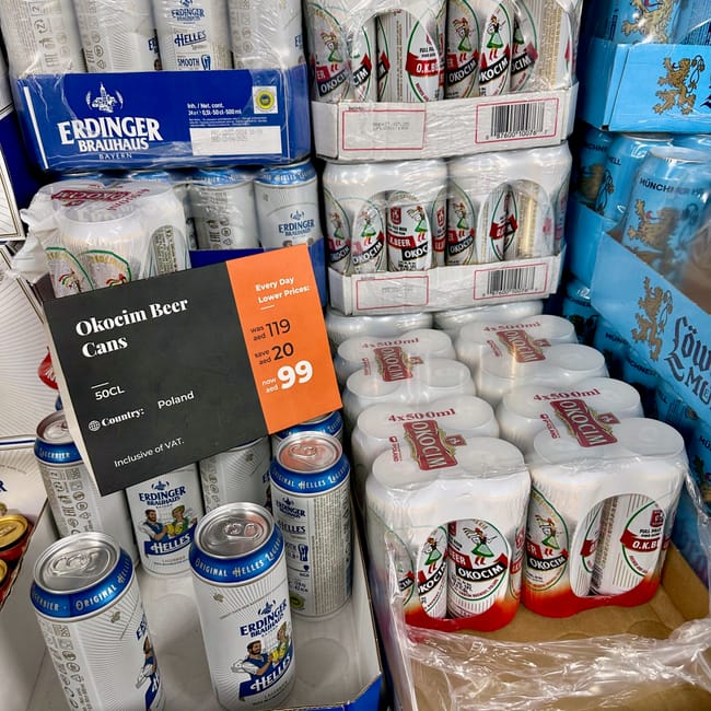 Półki z piwem w sklepie african eastern w dubaju, z markami erdinger, okocim i münchner hell.