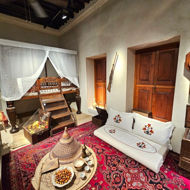 Wnętrze sharjah fort w uae z tradycyjnym łożem, dywanem i niskim stołem z herbatą.