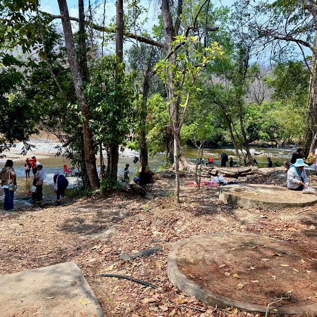Doi inthanon w chiang mai, ludzie odpoczywają nad leśną rzeką.