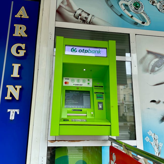 Green otprbank atm at a moldova, chisinau atm storefront with a visa cash-out screen
