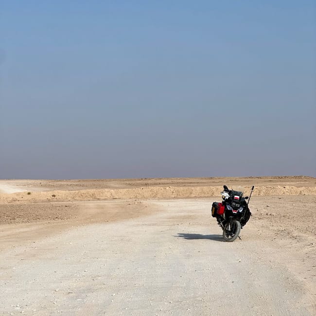 Motorcycle adventure on the edge of the world in saudi arabia with a desert horizon backdrop