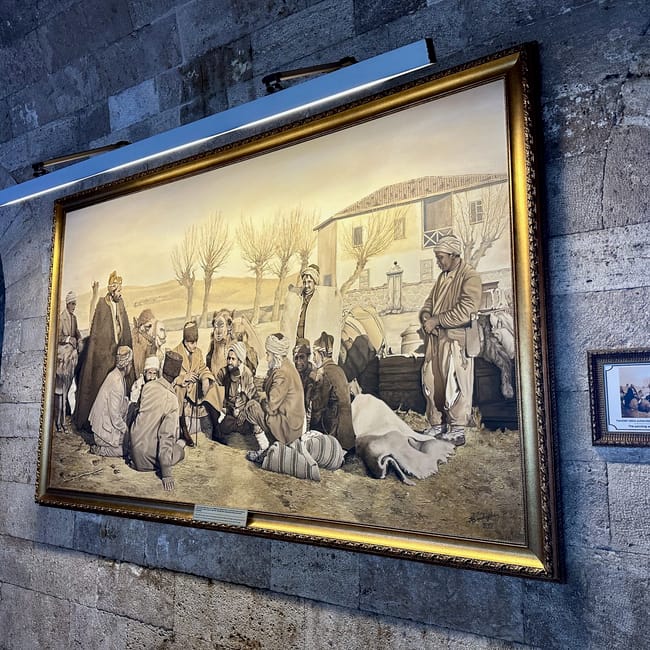 Turkey, ankara antikabir: framed mural depicting a group of figures in historic dress on a stone wall
