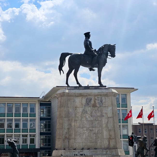 Turkey, ankara ataturk statue: bronze atatürk on horseback atop a stone pedestal under a blue sky