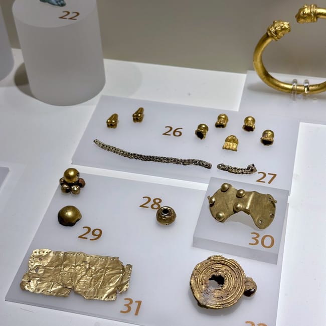 Turkey ankara civilization museum display case with numbered gold artifacts and jewelry, including rings and bracelets
