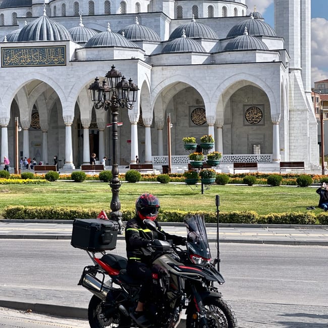 Motocyklista na ulicy w ankarze przed dużym meczetem