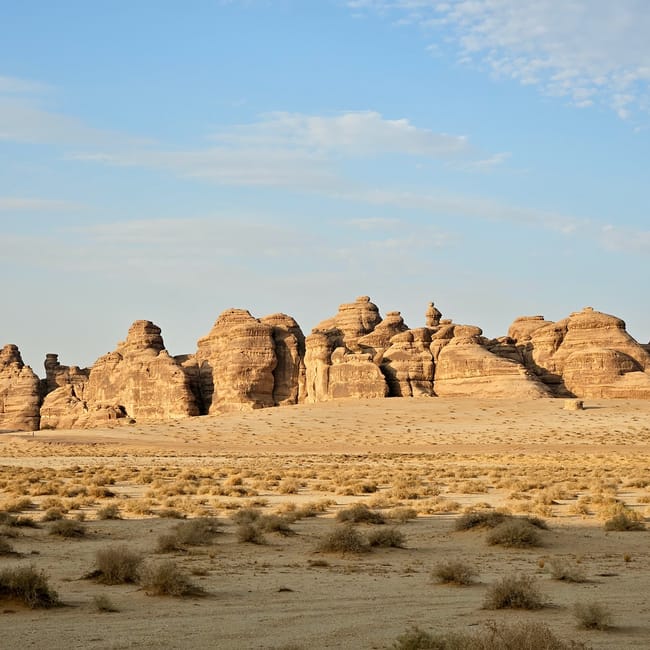 Al ula in saudi arabia desert landscape with sandstone rock formations under a blue sky