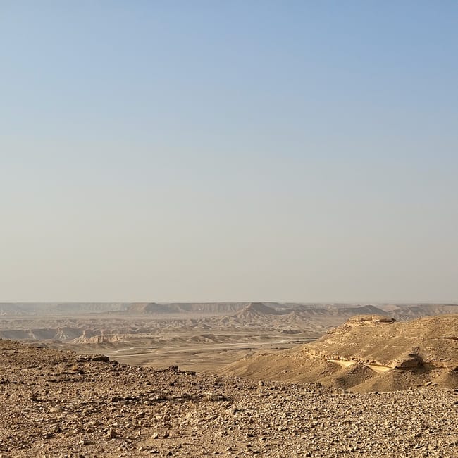Saudi arabia, edge of the world, rocky desert landscape with a vast canyon under a clear sky
